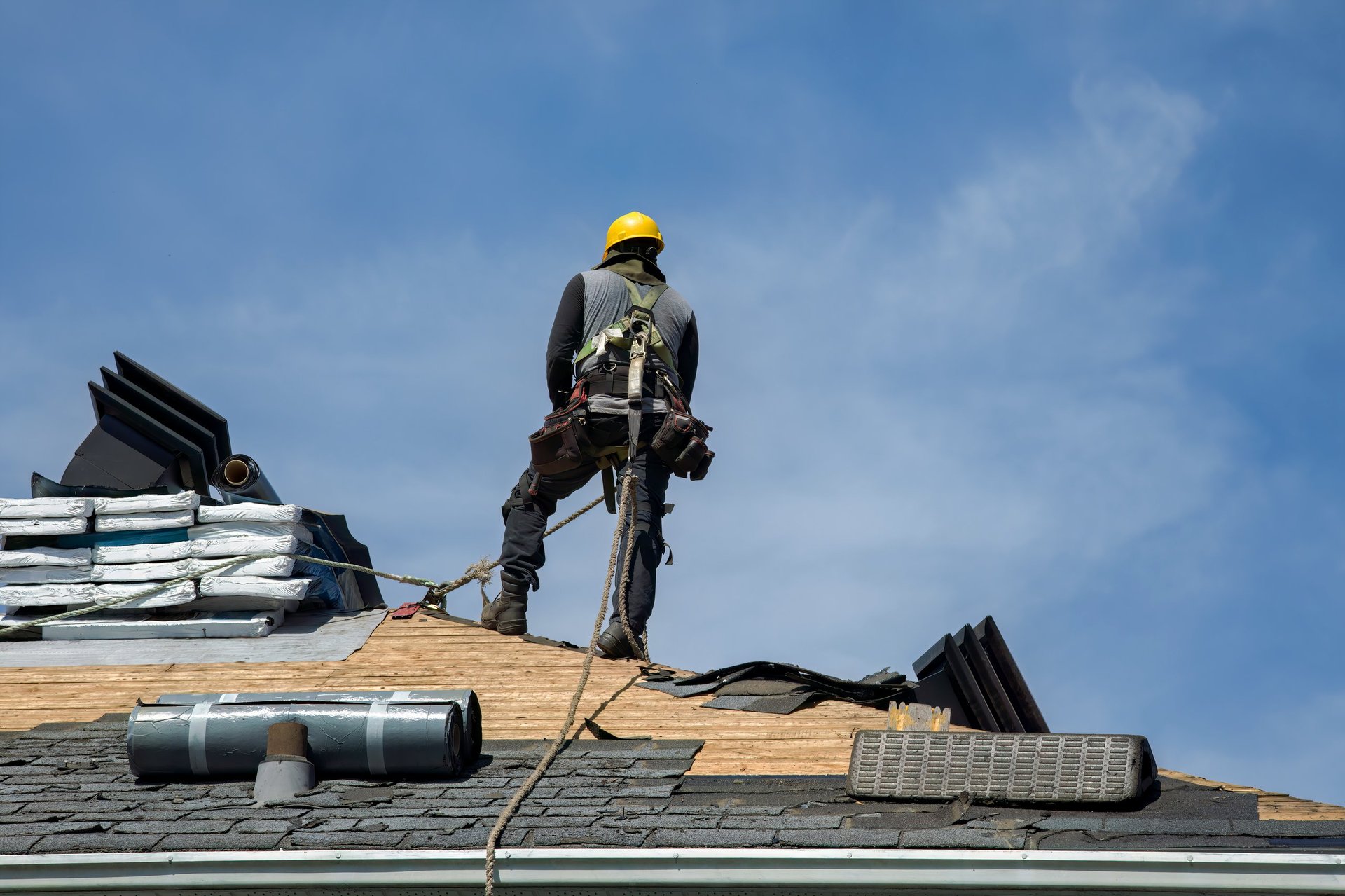 Construction worker applying roofing materials